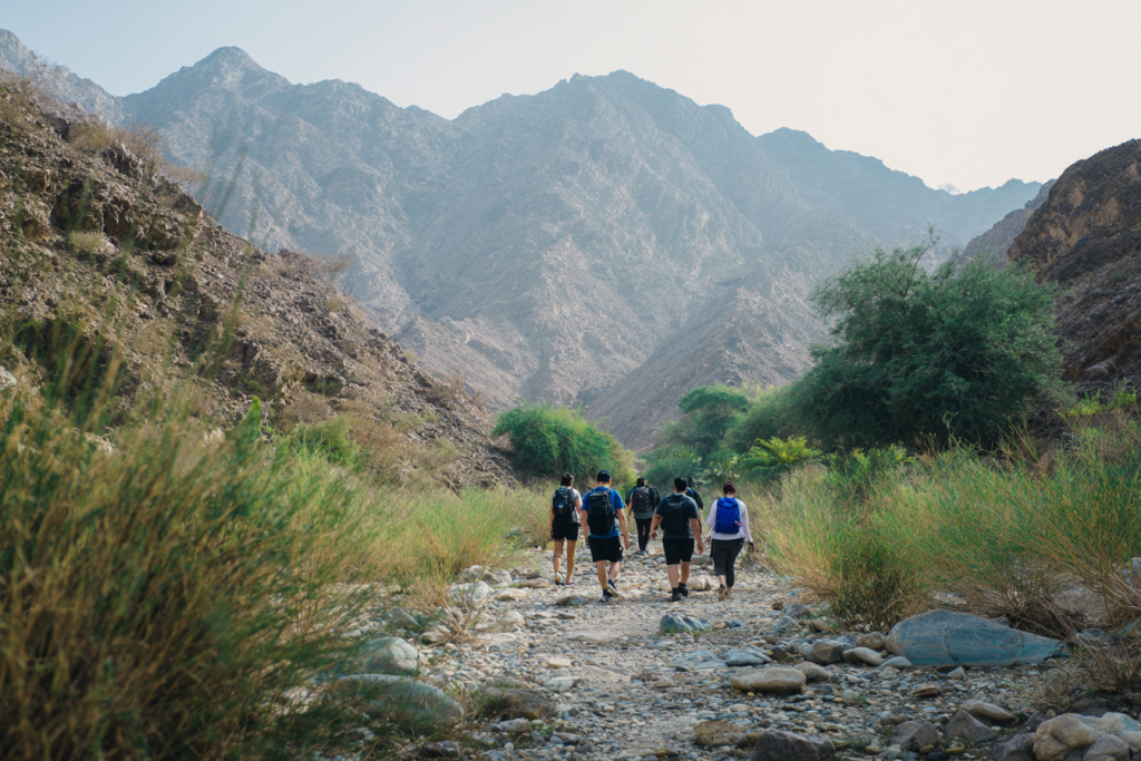 Guided hiking group walking through Wadi Al Dhahir trail in Fujairah UAE